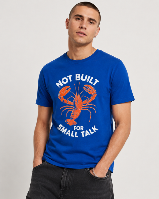 Model wearing a royal blue tee with a Not Built for Small Talk lobster design