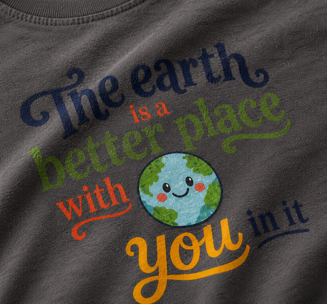 Gray shirt with motivational quote about the Earth and a smiley face design on a dark background