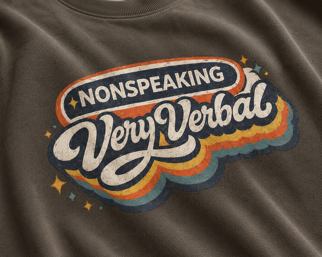 T-shirt with 'Nonspeaking Very Verbal' graphic design on a brown fabric background