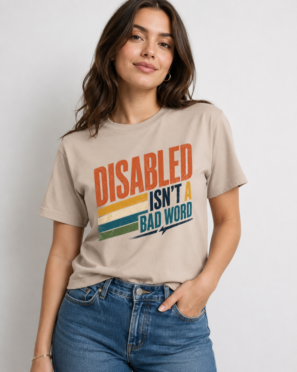 Image tan shirt with text in colorful design " Disabled isn't a bad word" 