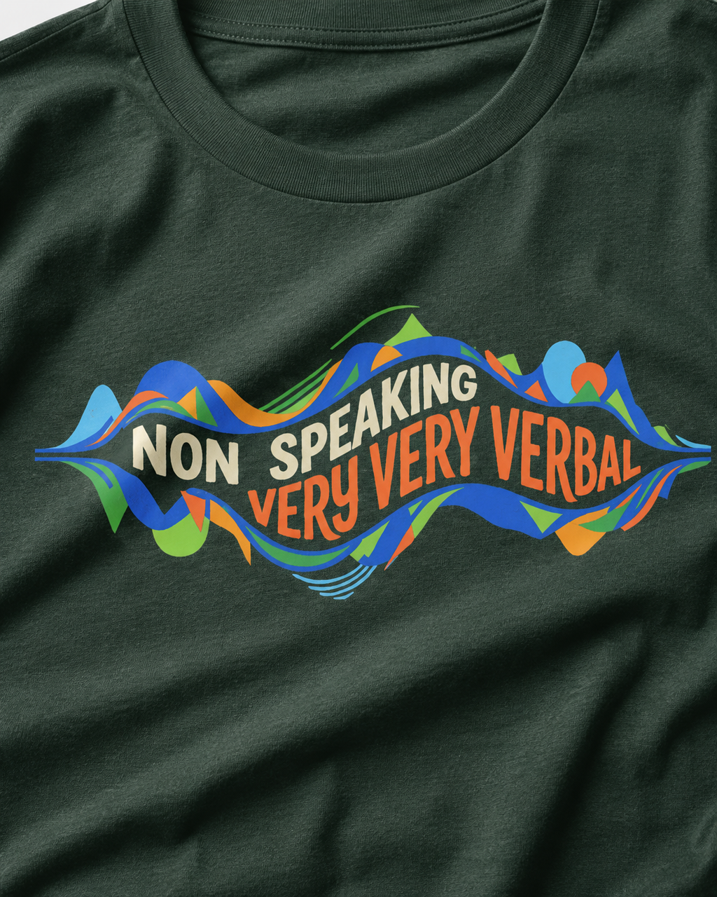 Green t-shirt with colorful text design on a plain background