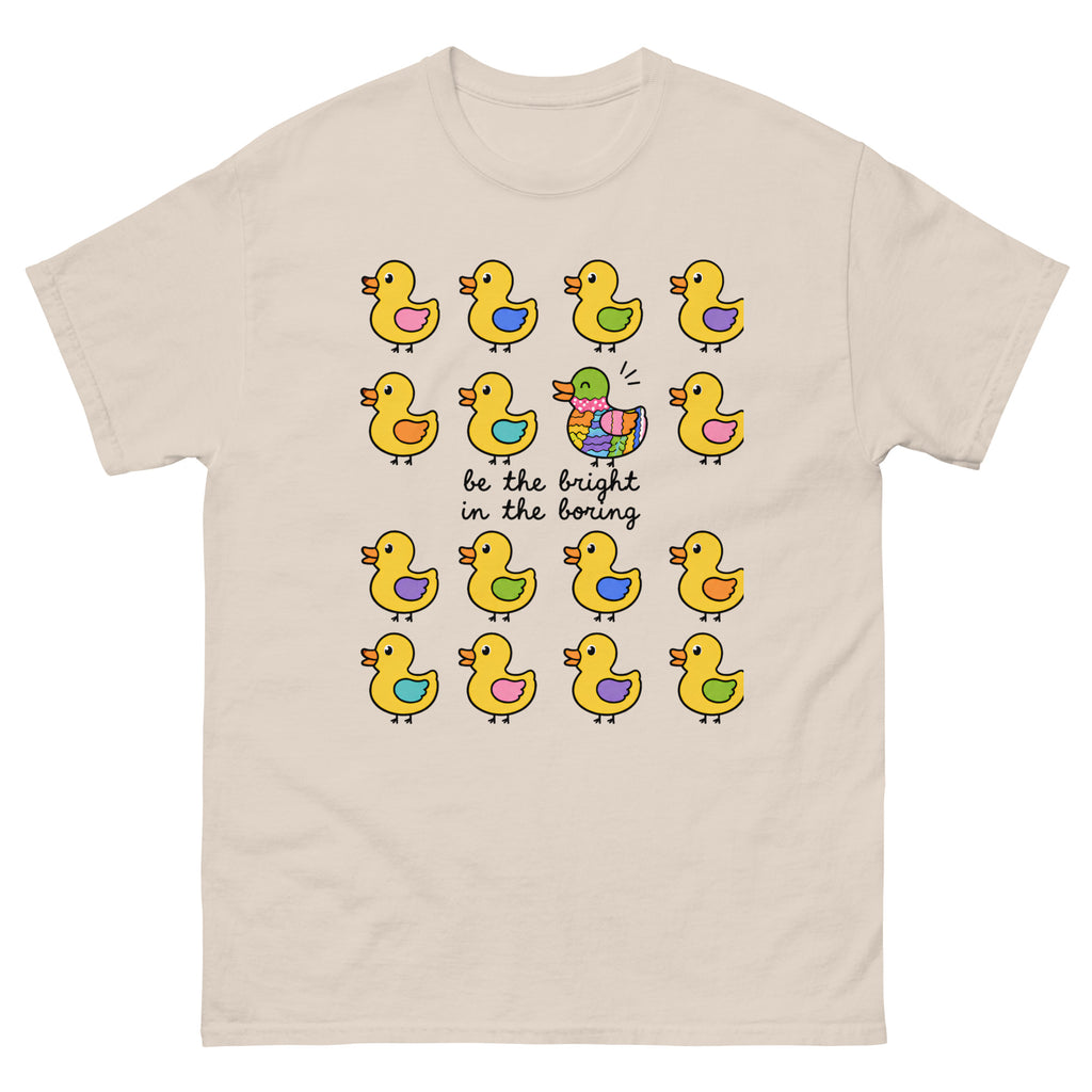 Product mockup shows colurful ducks on a beige shirt with a central message be the bright in the boring diability advocacy