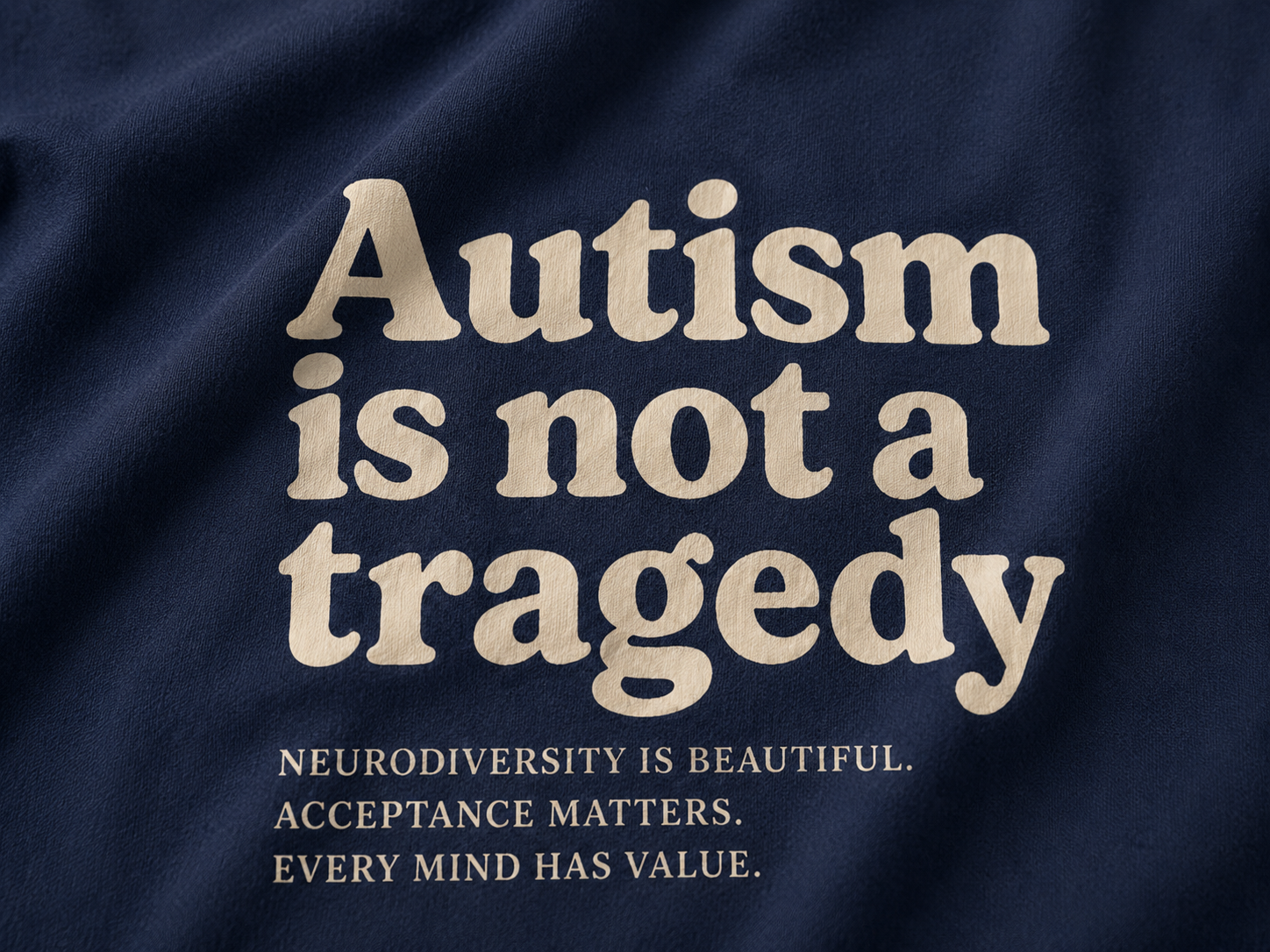 Text on a dark fabric background advocating for autism acceptance and neurodiversity.