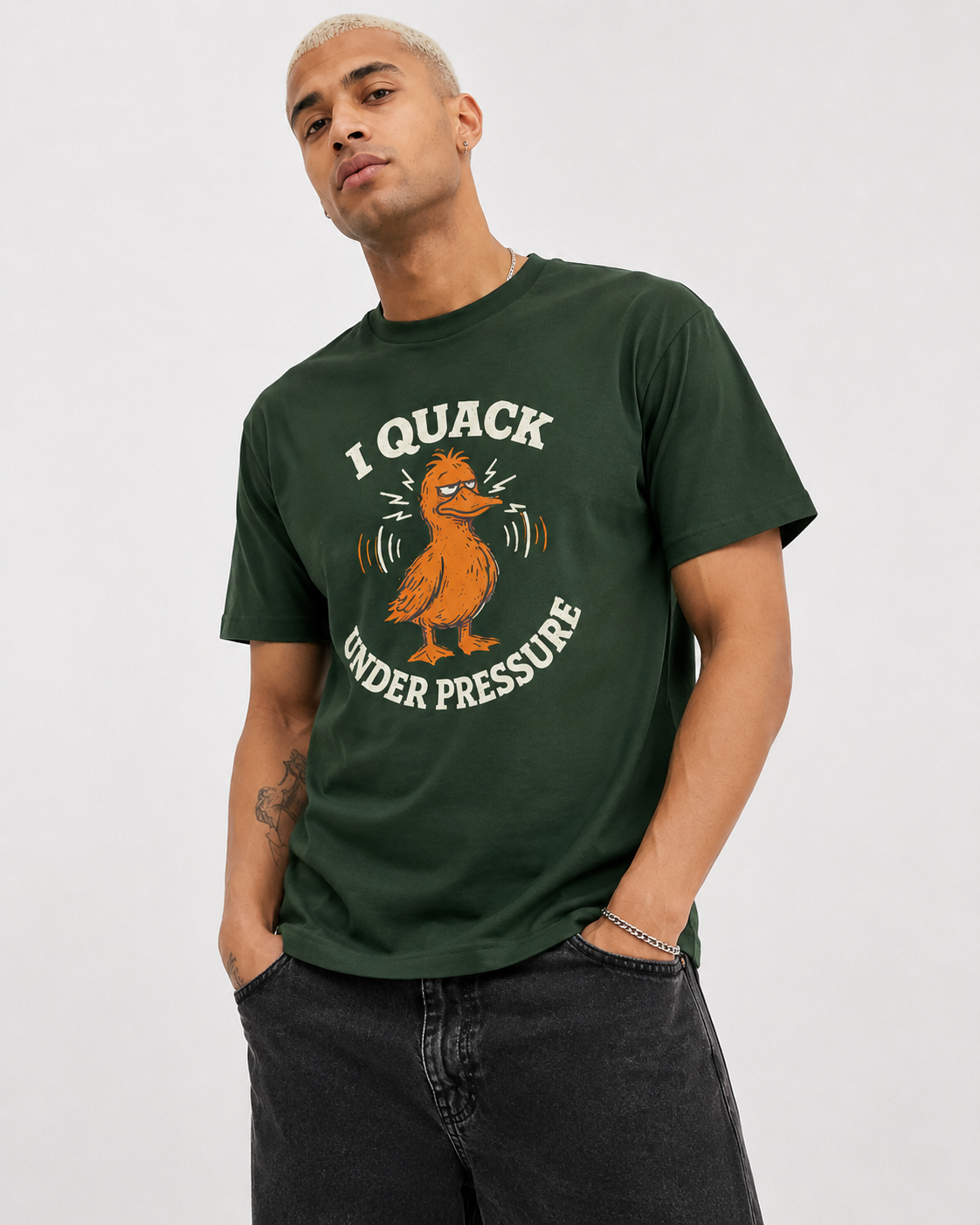 Person wearing a green t-shirt with a duck graphic and text on a plain background