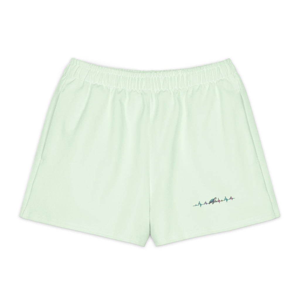 Product mockup of green short with turtle riding audiowave